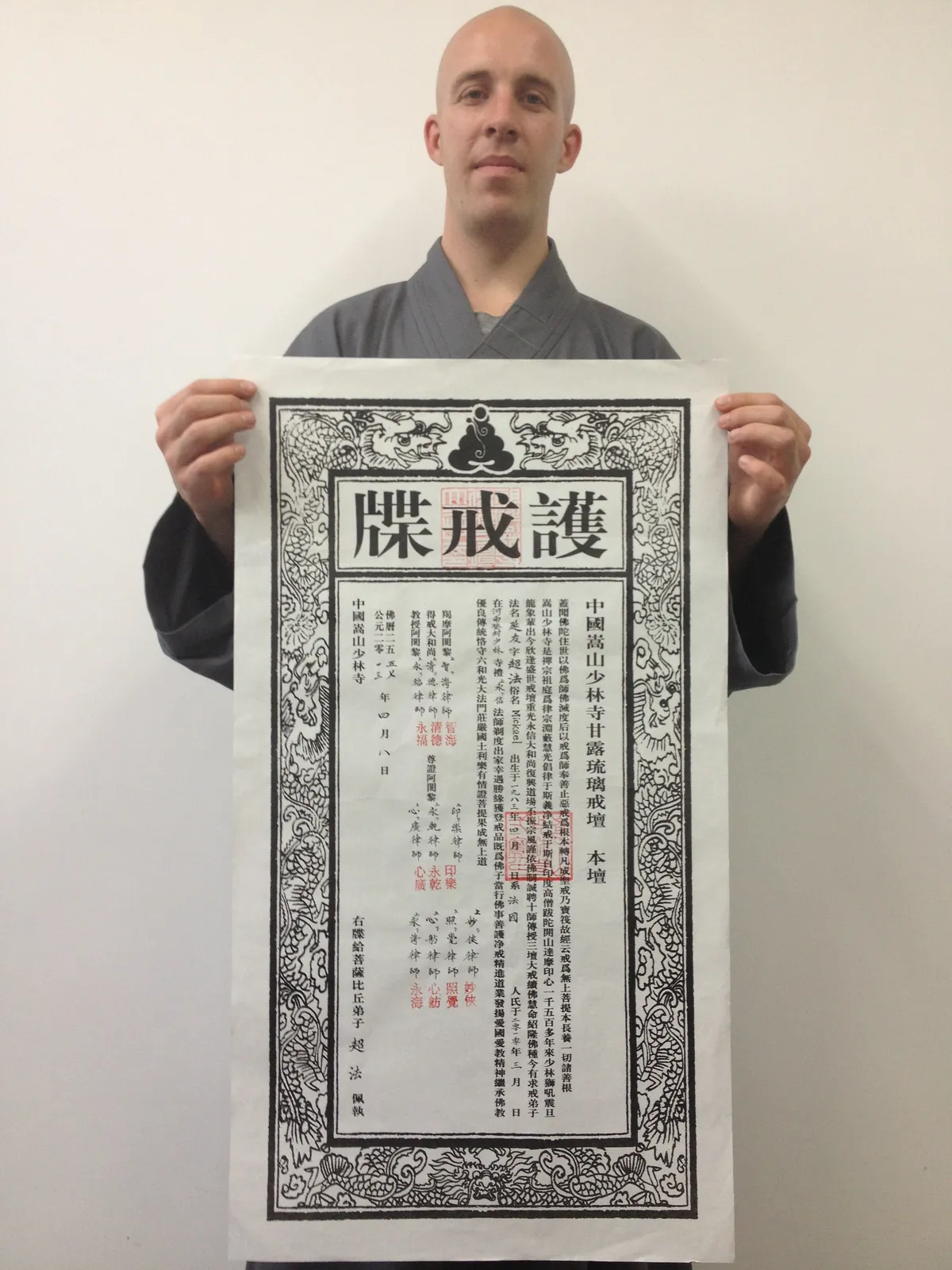 Maître Shi Yan You tenant son certificat traditionnel d'ordination